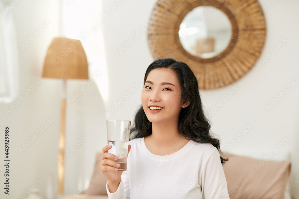 Asia woman drinking water on sofa Asia woman drinking water on sofa
