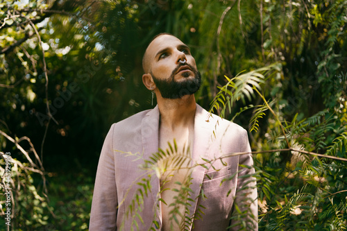 Male model posing with modern style at forest photo