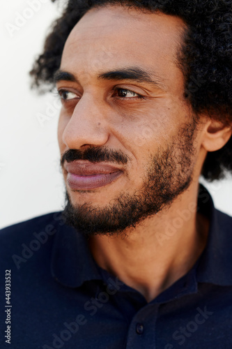 Smiling young man glancing sideways