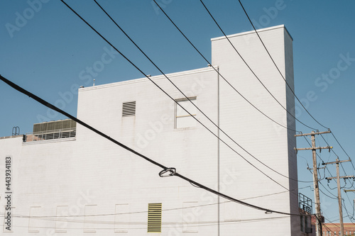 Pure white architecture with power lines