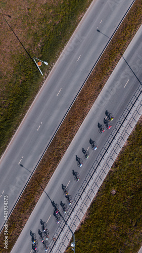 Group of road cyclists racing fast photo