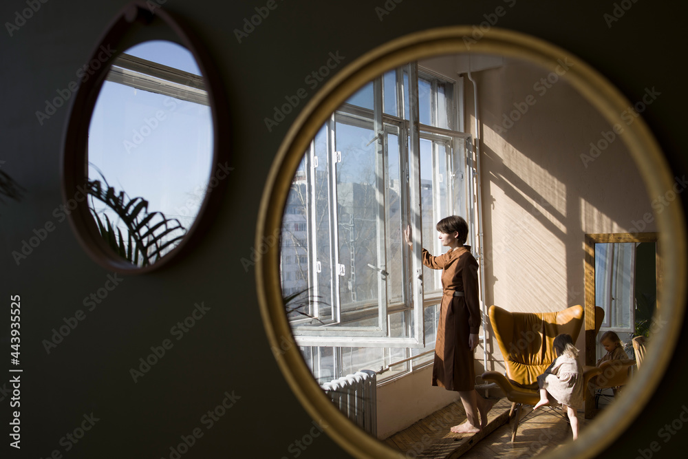 Reflection of mother looking out window Stock Photo | Adobe Stock