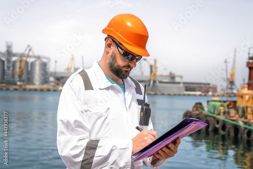 Seaman or port worker fills checklist photo