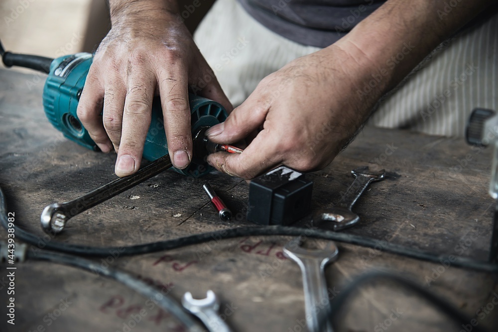 Man preparing electric router laminate trimmer machine tool - carpenter workshop concept Man preparing electric router laminate trimmer machine tool - carpenter workshop concept