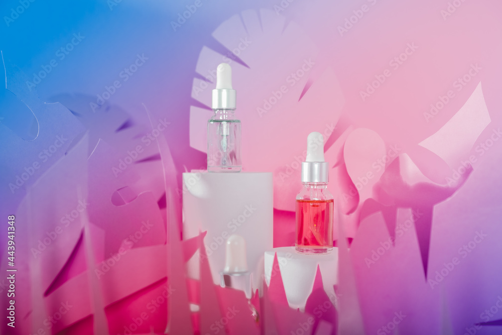 Dropper glass bottles with pipette standing on a white podium. Transparent hyaluronic natural beauty mineral product and eco serum skin care concept. Dropper glass bottles with pipette standing on a white podium. Transparent hyaluronic natural beauty mineral product and eco serum skin care concept.