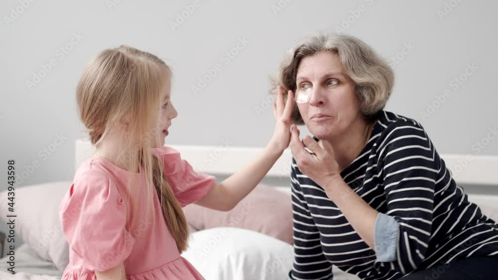 Grandmother spending time with her granddaughter in the bedroom Grandmother spending time with her granddaughter in the bedroom