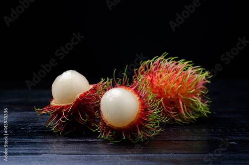 Fresh and ripe rambutan fruit with a sweet taste on black background. photo