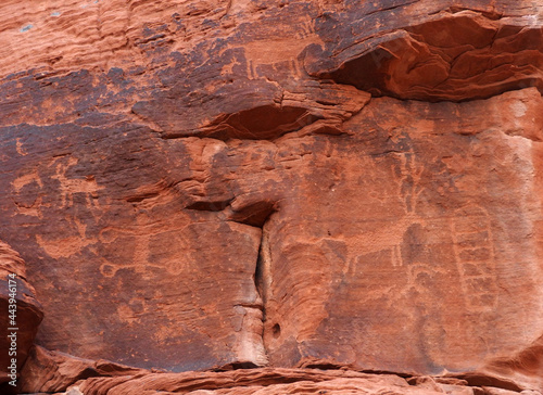 the  ancient native american petroglyphs along the petroglyph canyon trail near mouse's tank  in the  arid and eroded desert landscape of valley of fire state park, near overton, nevada photo