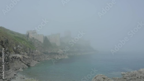 Stunning View Of Castle Of The Rock Goyon (Fort la Latte) In Fog. Impressive Castle At The Bay Of Saint-Malo In Plevenon, France. drone approach photo