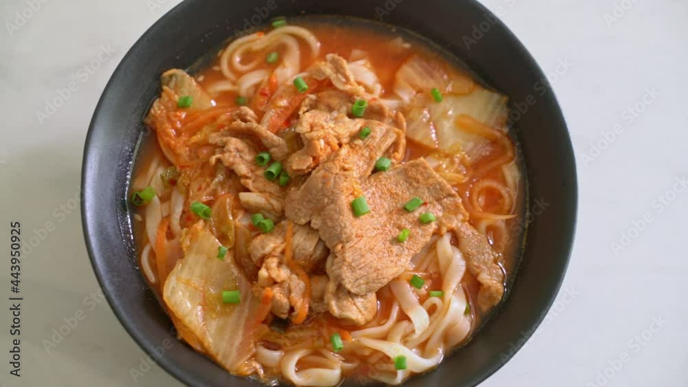 Korean udon ramen noodles with pork in kimchi soup - Asian food style Korean udon ramen noodles with pork in kimchi soup - Asian food style