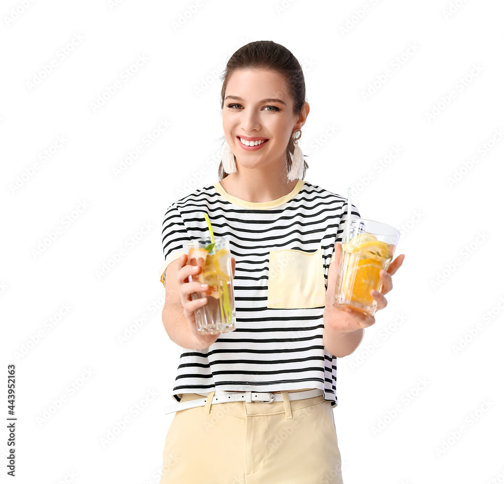 Young woman with fresh lemonade on light background