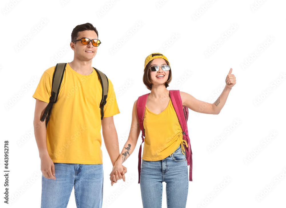 Young couple hitchhiking on white background