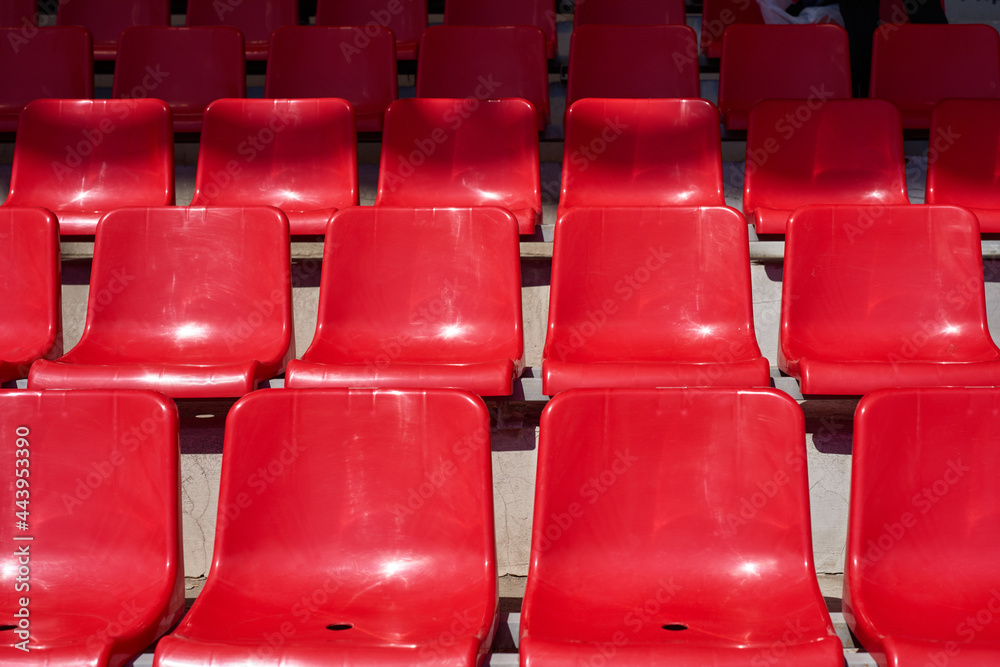 Empty stadium with red rows of chairs Empty stadium with red rows of chairs