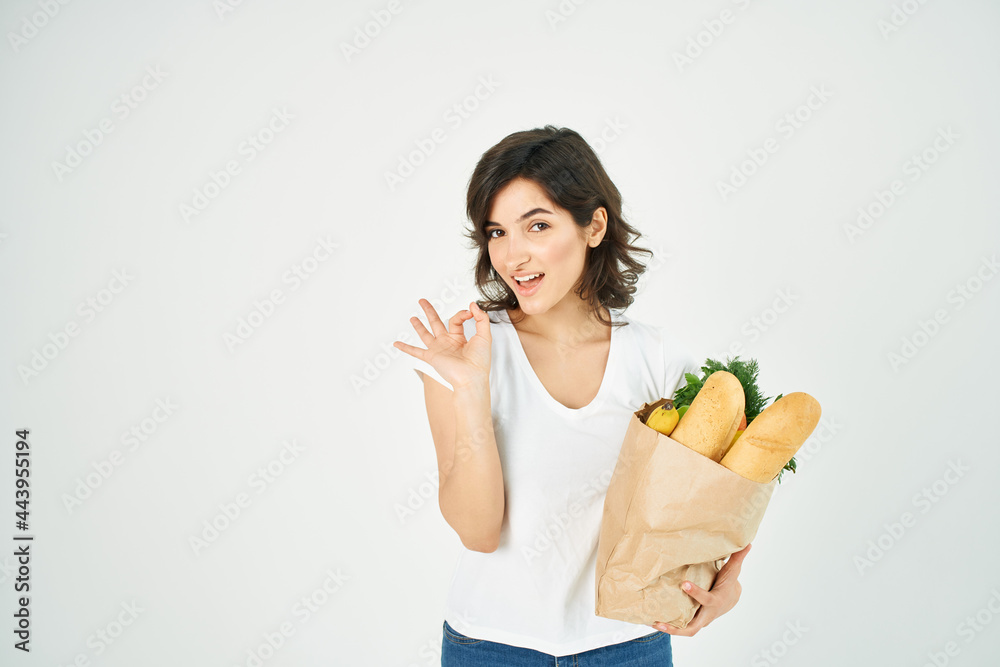 cute brunette in white t-shirt package with vegetables groceries supermarket cute brunette in white t-shirt package with vegetables groceries supermarket