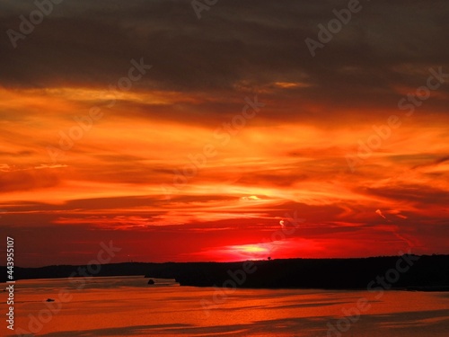 fiery sunset over the water in osage beach,  lake of the  ozarks, , missouri photo