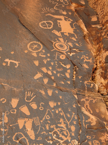 footprints  and symbols in the ancient native american newspaper rock petroglyphs near  canyonlands national park, utah photo