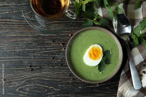 Concept of healthy food with nettle soup on wooden table photo