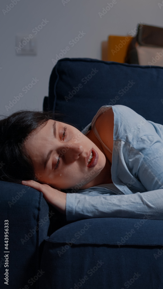 Unhappy depressed woman crying lying on sofa suffering from insomnia, depression psychological problem, bipolar disorder loneliness, frustration anxiety. Stressed unhealthy lonely person feeling tired