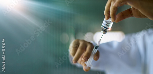 .Medical research and development  Doctor hands injecting Covid-19 vaccine into glass syringe. Experimental result in laboratory  immune system and Covid-19 global vaccination coverage.