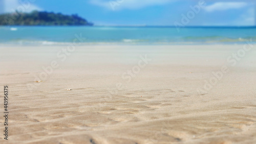 Soft sand on tropical beach and blue sea with summer sky.