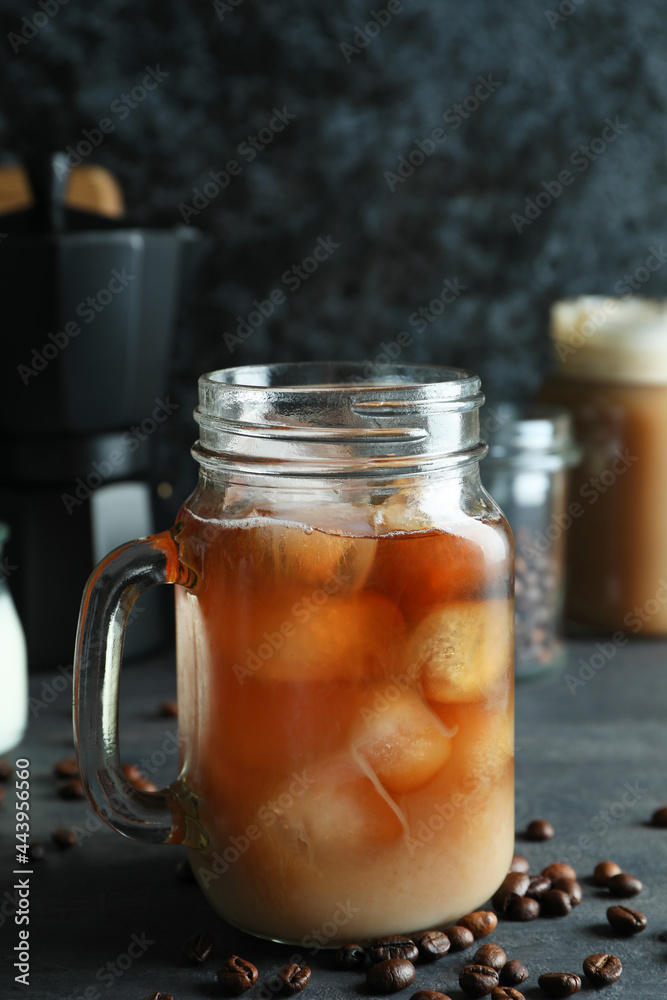 Concept of delicious drink with ice coffee on dark wooden table Concept of delicious drink with ice coffee on dark wooden table
