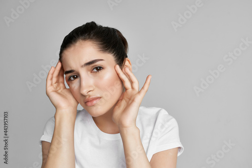woman with headache dissatisfaction health problems medicine light background
