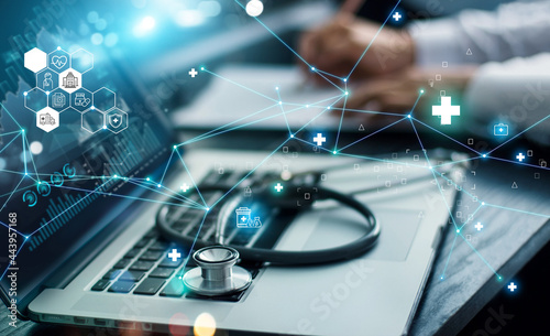 .Healthcare business graph data and growth, Insurance Healthcare. Doctor analyzing medical of business report and medical examination with network connection on laptop screen. photo