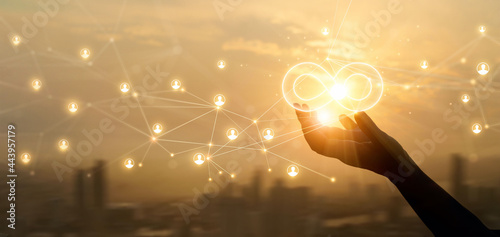 Hands holding sign of infinity on global customer network connection. Digital marketing and unlimited market on  networking.