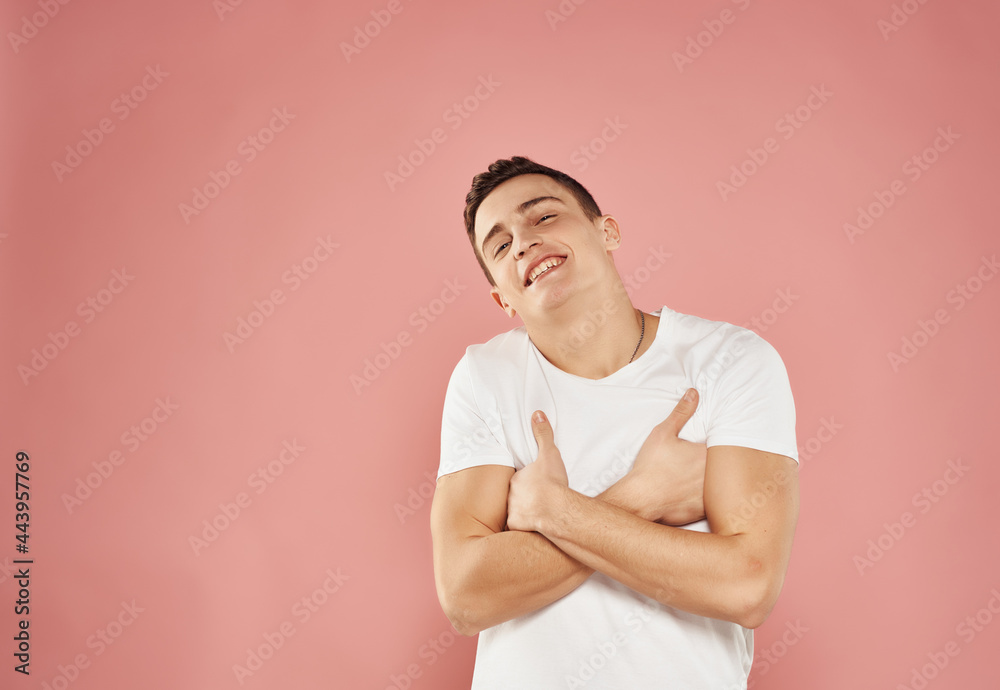 handsome man fun gesture with hands pink background emotions