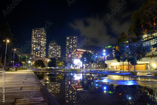 Low angle night city lights and reflections at Darling Harbour. © gshakwon