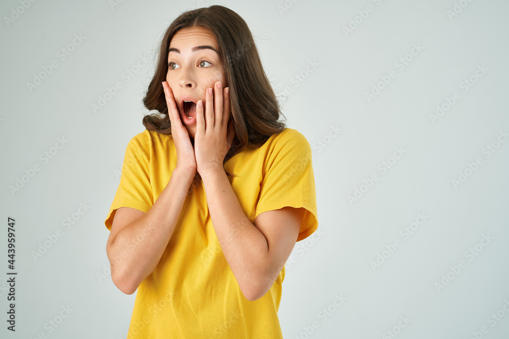 surprised brunette in a yellow t-shirt stress emotions frustration negative surprised brunette in a yellow t-shirt stress emotions frustration negative