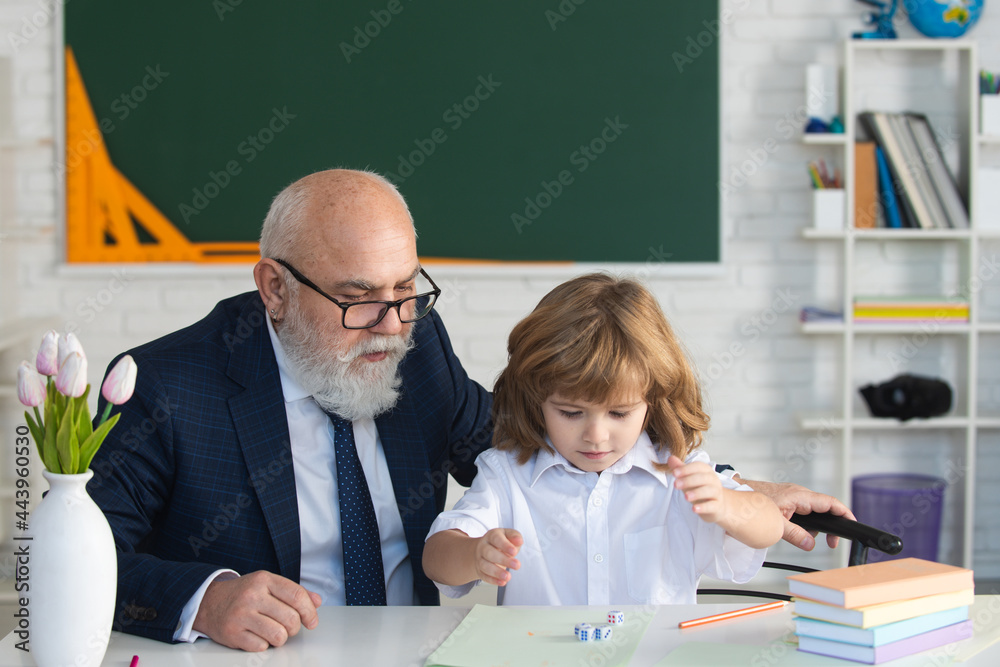 Old senior teacher and young student or school boy. Private lesson. Old senior teacher and young student or school boy. Private lesson.
