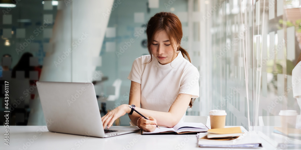 portrait of busy business woman two hand cross working and sitting at workplace while with work in office. portrait of busy business woman two hand cross working and sitting at workplace while with work in office.