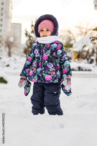 little child playing in snow