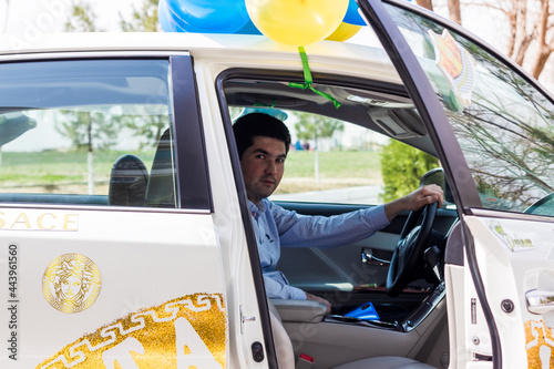 a young man in a white decorated car