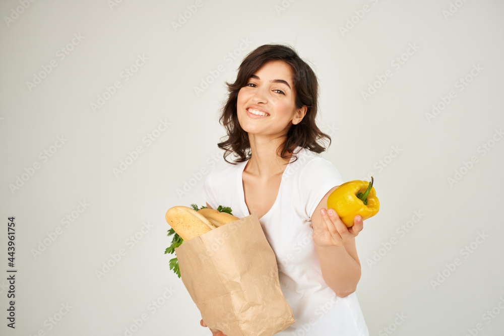 brunette with a package of yellow pepper products in the hands of health vegetables brunette with a package of yellow pepper products in the hands of health vegetables