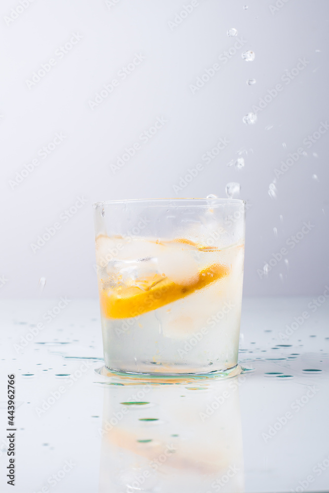 Orange fell in a glass with water isolated on white Orange fell in a glass with water isolated on white