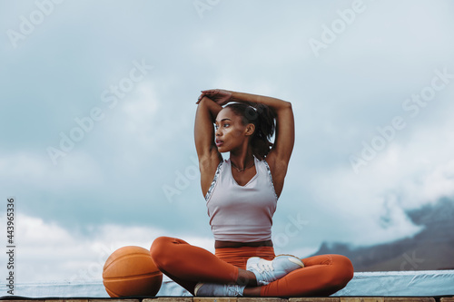 Healthy woman taking break from workout on rooftop photo