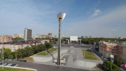 Flight around epic Theater square Nika stella liberators Rostov on don Russia scenic cityscape. Golden woman on top. Skyline. Downtown. Blue sky clouds. Travel attraction best landmark. Road traffic photo