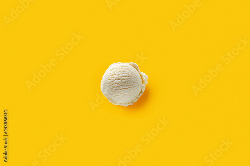 Ball of white ice cream on yellow background