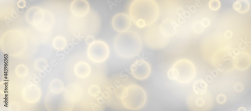 Silver bokeh background. Christmas glowing silver and golden lights with sparkles. Holiday decorative effect.