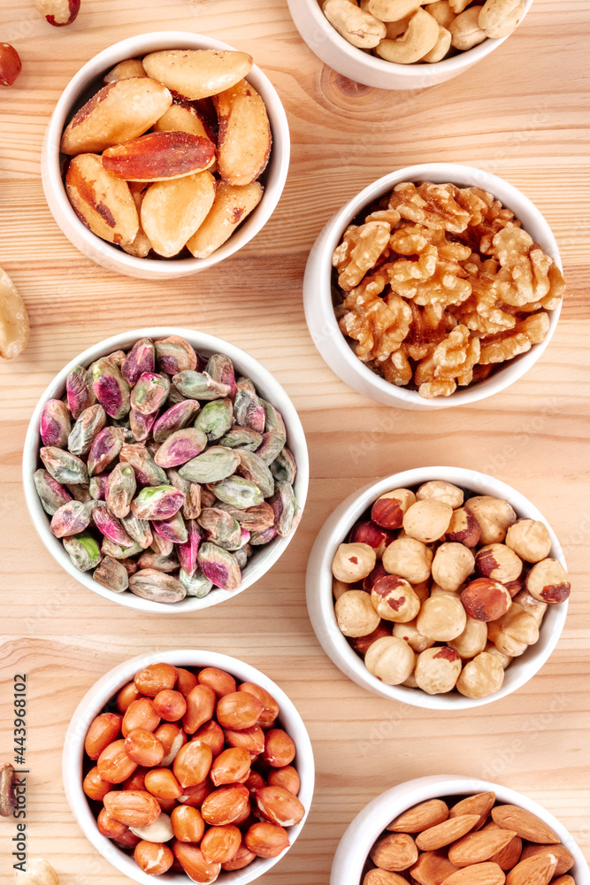 Nuts in bowls, shot from the top on a rustic wooden background. Pistachios, walnuts, Brazil nuts Nuts in bowls, shot from the top on a rustic wooden background. Pistachios, walnuts, Brazil nuts