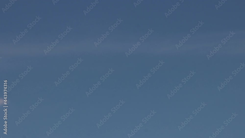 A giant satellite dish for receiving a signal is aimed up to the blue sky. A giant satellite dish for receiving a signal is aimed up to the blue sky.
