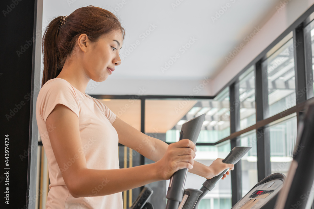Workout woman, girl, exercise on elliptical cross trainer in fit sportswear, practice working out training for health. Sport strong person in gym fitness for healthy lifestyle, recreation concept.4 Workout woman, girl, exercise on elliptical cross trainer in fit sportswear, practice working out training for health. Sport strong person in gym fitness for healthy lifestyle, recreation concept.4