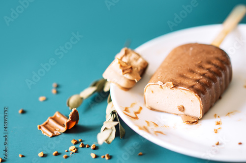 Bild auf Leinwand Chocolate Popsicles cut with filling lying on white plate on cian background
