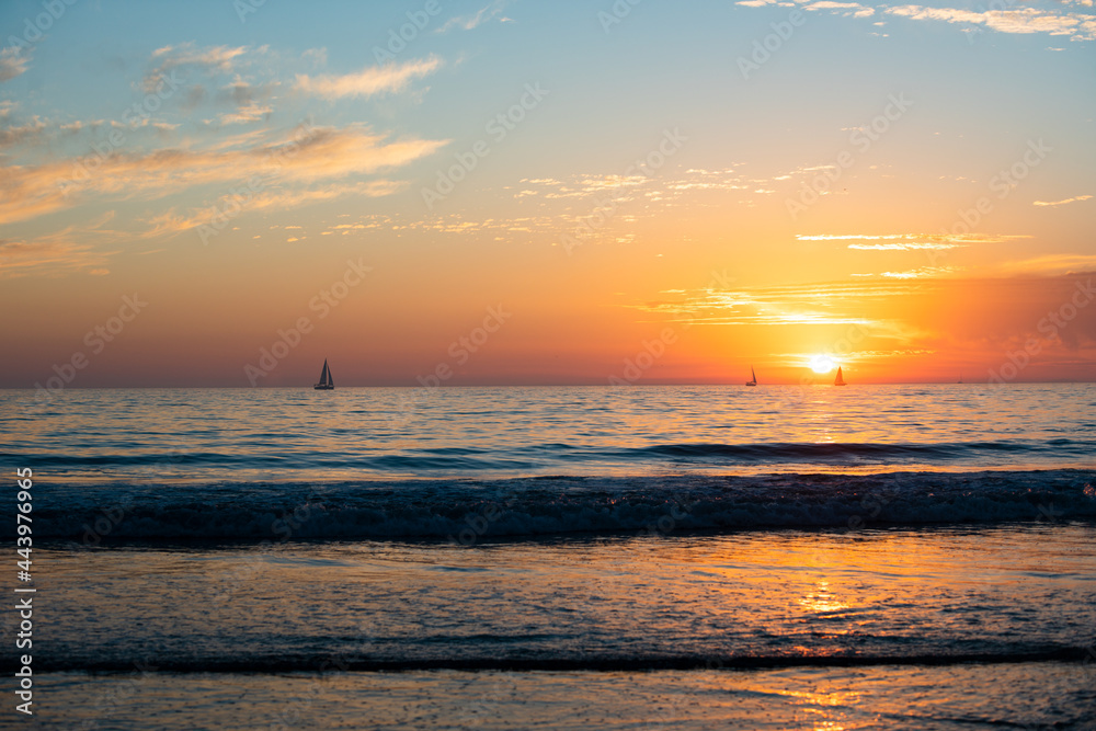 Sunrise over the sea and beautiful cloudscape. Colorful ocean beach sunset.