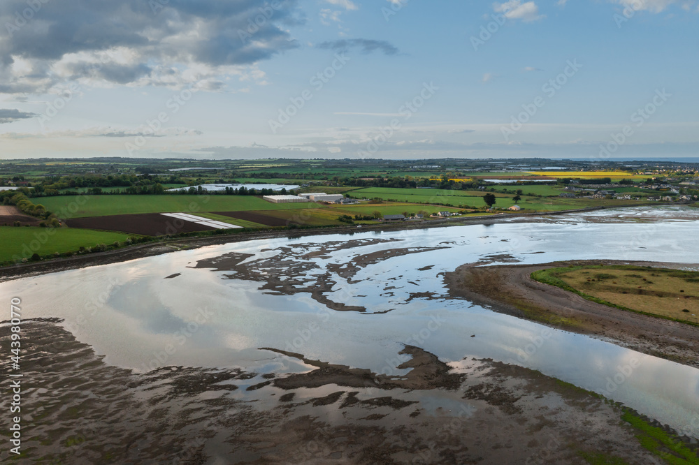 Irish textured landscape and water reflections at sunset.Rogerstown Estuary at sunset, aerial view.