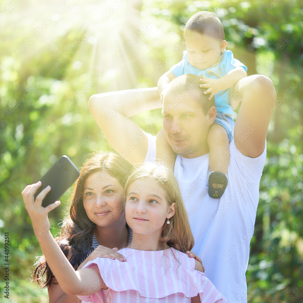 Fototapeta premium Photo of family taking selfie in the nature