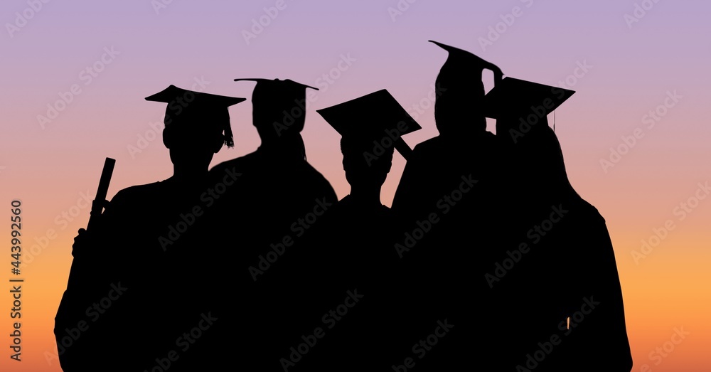 Fototapeta premium Composition of silhouettes of graduating students in caps and gowns against sunset sky