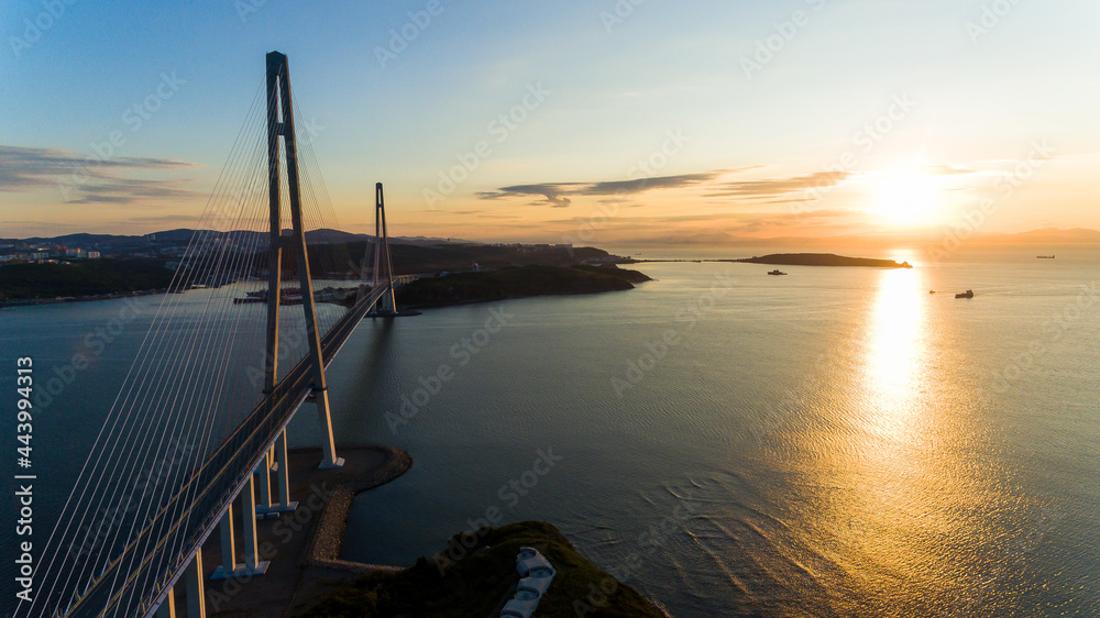 Russian bridge across the Eastern Bosphorus Strait in Vladivostok. View from above. Russian bridge against the background of a beautiful sunrise. Russian bridge across the Eastern Bosphorus Strait in Vladivostok. View from above. Russian bridge against the background of a beautiful sunrise.